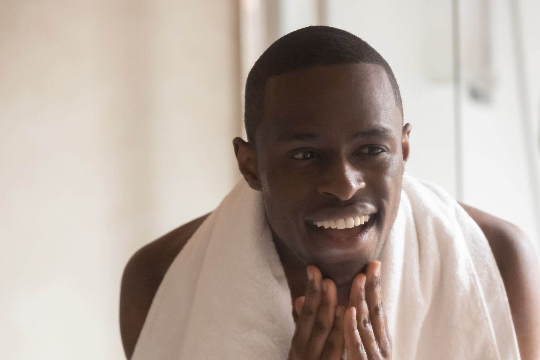 Micro Needling for Men man looking in mirror after receiving micro needling in Reno Tahoe